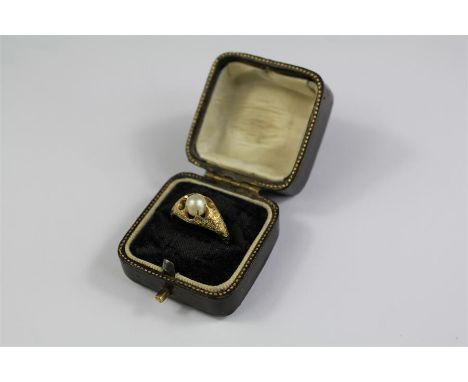 An 18ct Yellow Gold Natural Round Saltwater Pearl Ring. The natural pearl approx 6.0 - 6.1mm set in a finely engraved mount, 