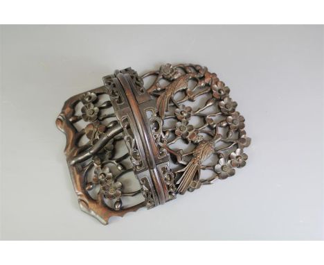 A Chinese Carved Wall Bracket. The bracket has a low gallery and is carved with birds and flowers, approx 29 x 22 cms.&nbsp;