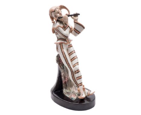 A Goldscheider figure of a jester: playing a pipe and leaning against a column draped with a cloth, printed factory mark and 