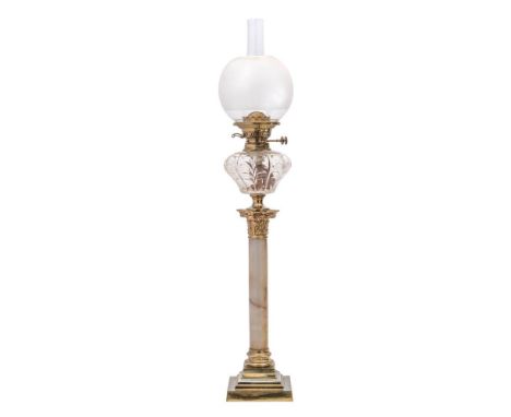 A late Victorian brass and onyx oil lamp: with clear cut glass reservoir, mounted on a Corinthian capital and onyx column wit