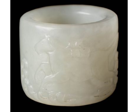 A Chinese jade archer's ring: carved in low relief with a dragon-horse carrying a bundle of scrolls tied to its back above wa
