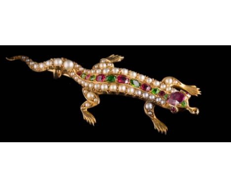 A demantoid garnet, ruby, seed-pearl and gem-set 'lizard' brooch: the ruby inset head with ruby eyes and garnet nose, the cla