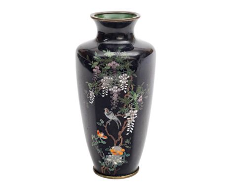 A Japanese cloisonne vase:, of hexagonal ovoid form decorated with an exotic bird perched amongst flowering wisteria to a dar