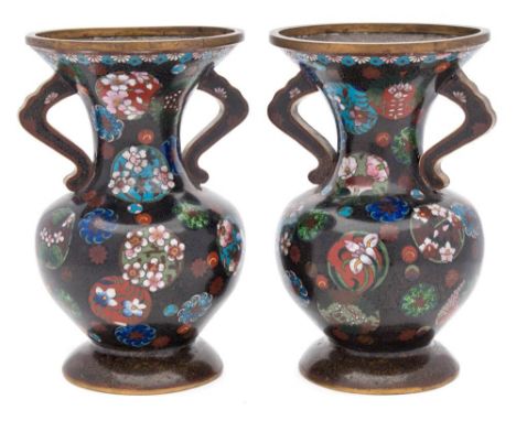 A pair of Japanese cloisonne vases: of ovoid waisted form, decorated with circular panels of blossom and flowerheads, on a sp