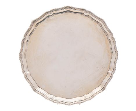 A George VI silver salver, maker Mappin &amp; Webb, Birmingham, 1937: of circular outline with wavy edge beaded border, raise