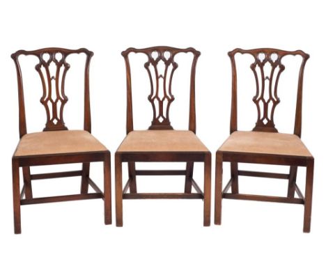 A set of six carved mahogany dining chairs in the Chippendale taste:, the backs with serpentine top rails and pierced central