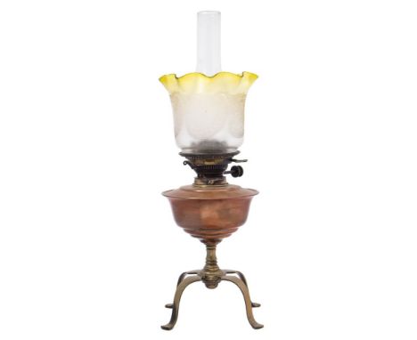 An Arts and Crafts copper and brass oil lamp by Benson: the copper reservoir raised on a knopped stem on four swept brass leg