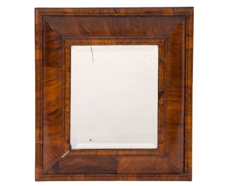 An 18th Century walnut cushion frame wall mirror:, with later inset rectangular bevelled plate, within a moulded surround, 52