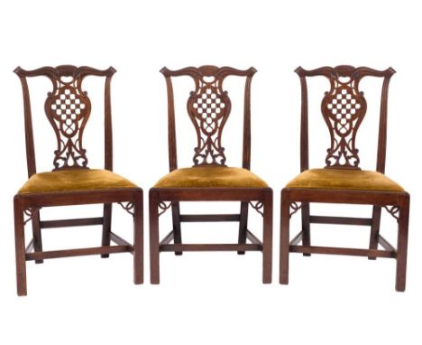 A set of six George III carved mahogany dining chairs:, in the Chippendale taste, the backs with moulded, scroll shaped top r