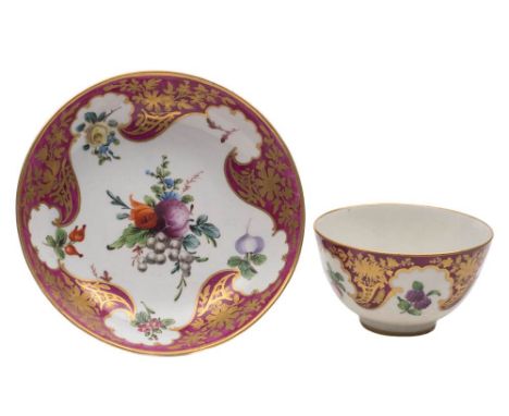 A First Period  Worcester teabowl and saucer: painted in 'Hope Edwards' style with a bunch and single flowers and fruit withi