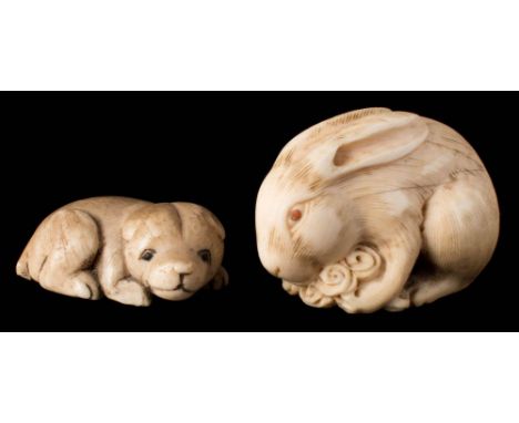 A Japanese carved ivory netsuke:  of a rabbit or hare eating lettuce, signed, 4cm. long, together with another netsuke of a r