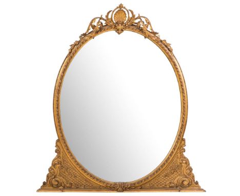 A Victorian giltwood and gesso oval overmantel mirror,: with pierced foliate scroll cresting centred by a scallop shell in be