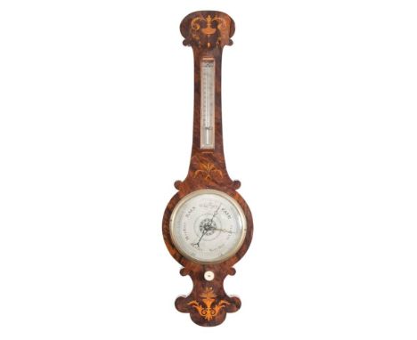 An Edwardian rosewood wheel barometer with inlaid decoration: the eight-inch round silverted dial engraved with typical barom