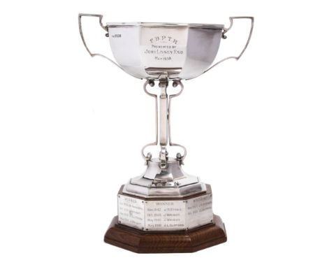 A George V silver trophy cup, maker Walker &amp; Hall, Sheffield, 1935: inscribed, of octagonal outline with two scroll handl