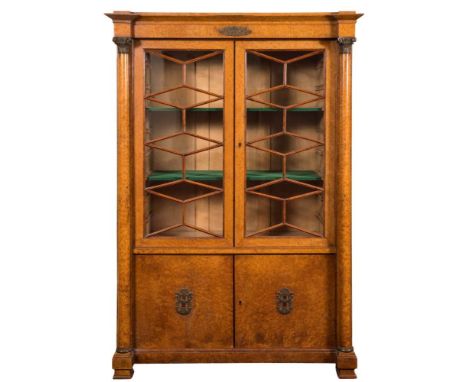 A French Charles X gilt metal mounted burr maple bookcase,: with a pair of astragal glazed doors enclosing two adjustable she