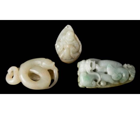 A Chinese carved jade pendant: of triangular outline with a seated figure wearing robes, 4.5cm. high, a carved jade figure of
