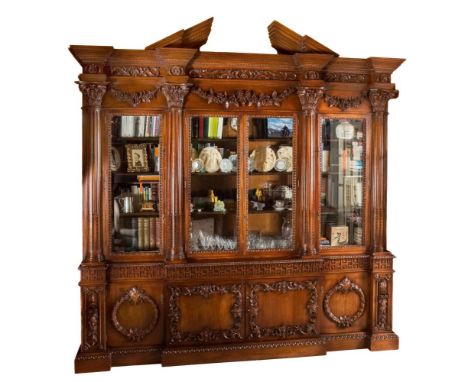 An 18th Century style carved mahogany breakfront library bookcase after the original by William Vile made for King George III