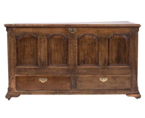 An 18th Century oak rectangular dower chest:, with a hinged moulded top, the quadruple fielded and crossbanded panel front fi