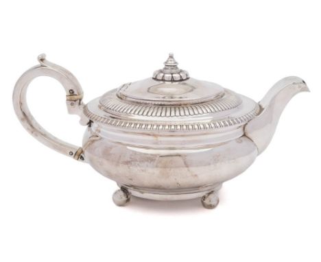 A George III silver teapot, maker Michael Starkey. London, 1811: of squat circular outline with gadrooned border and scroll h