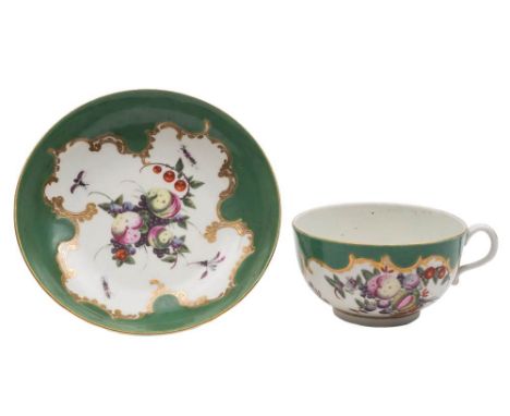 A First Period Worcester 'spotted fruit' teacup and saucer: painted with a variety of fruit and insects within scrolling gilt