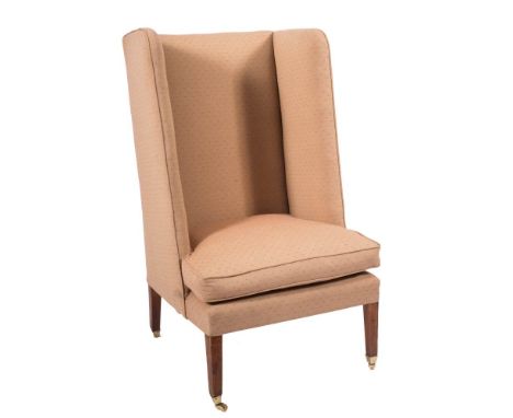 An Edwardian mahogany frame high wing back armchair:, fully upholstered in light brown patterned fabric on square tapering le