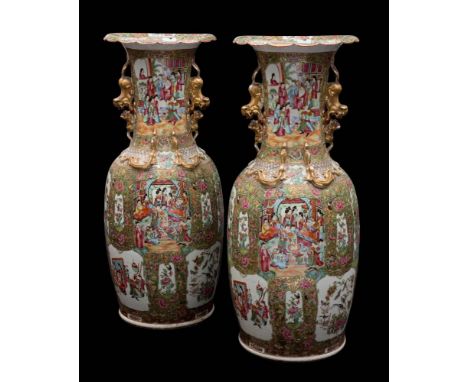 A pair of large Canton famille rose enamel baluster vases: with gilt double lion dog handles and applied with sinuous chilong