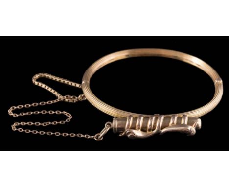 A hinged bangle with attached propelling pencil: the plain polished  propelling pencil within a snake motif, wire frame mount
