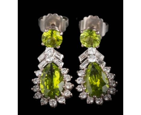 A pair of peridot and diamond drop earrings: each with a pear-shaped peridot, approximately 14.5mm long x 8mm wide, within a 