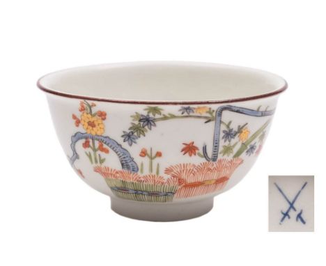 An early Meissen kakiemon teabowl: painted with a banded hedge and the 'Three Friends' of pine, bamboo and prunus, brown line