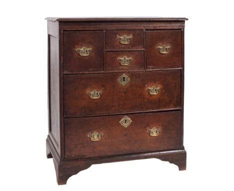 An early 18th century oak chest of small size:  the top with a moulded edge, fitted with an arrangement of four short and two