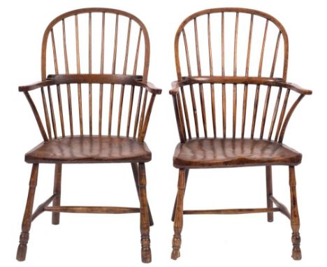 A harlequin set of four 19th Century elm, ash and fruitwood stick back Windsor elbow chairs:, with arched backs, shaped arm s