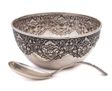 An Eastern silver bowl and ladle, stamped 800: the bowl with embossed flowerhead and foliate decoration 24.5cm. diameter with