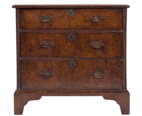 An 18th century walnut and crossbanded rectangular chest:, of comparatively small size, the quarter veneered and feather band