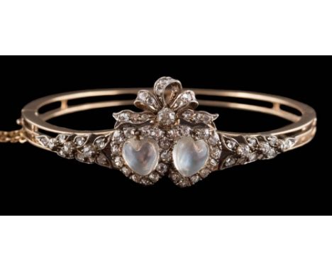 A 19th century gold, moonstone and diamond mounted hinged bangle: with two detachable heart-shaped moonstones set beneath a d