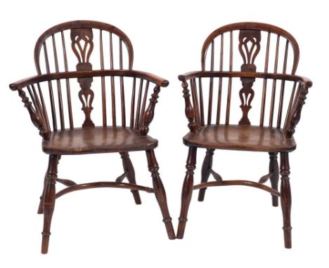 Two similar early 19th Century yew-wood and elm stick back Windsor elbow chairs:, the arched backs with pierced central vase 