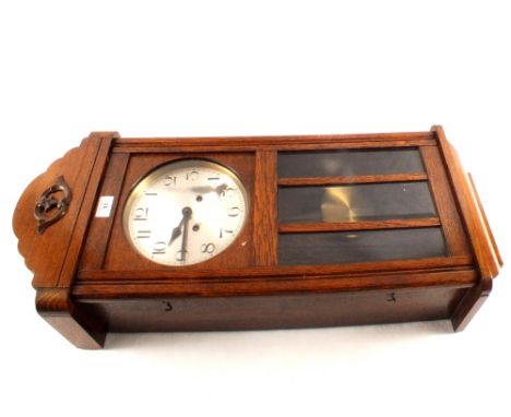 An oak striking wall clock plus a Singer sewing machine