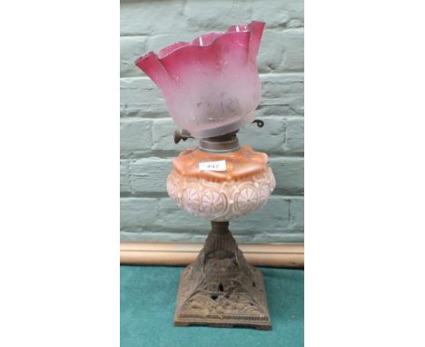 An iron and pink glass oil lamp plus a non-matching pink and etched glass shade