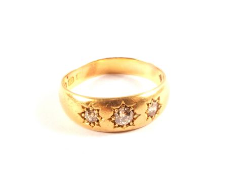 An 18ct gold three stone diamond gypsy ring, size P