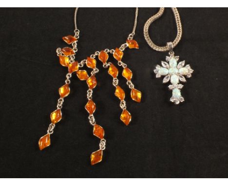 A silver amber set necklace and a silver opal and white stone set cross necklace on silver chain