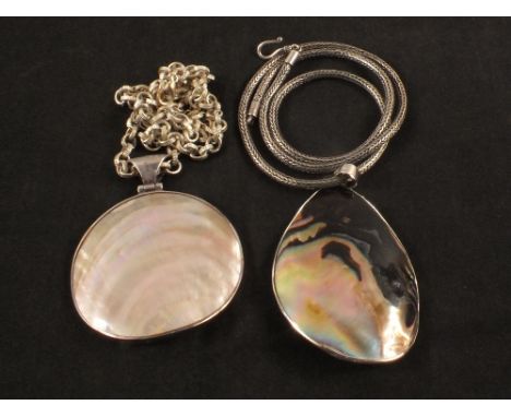 Two large silver mounted shell pendants, one on silver chain