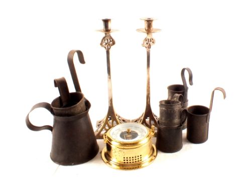 A circular brass barometer, metal candlesticks plus various measures