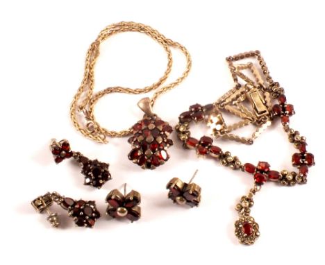 A large silver red stone and marcasite set necklace in floral design with similar earrings and another abstract silver pendan