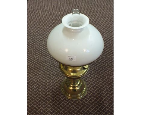 A brass oil lamp with milk shade and glass funnel 