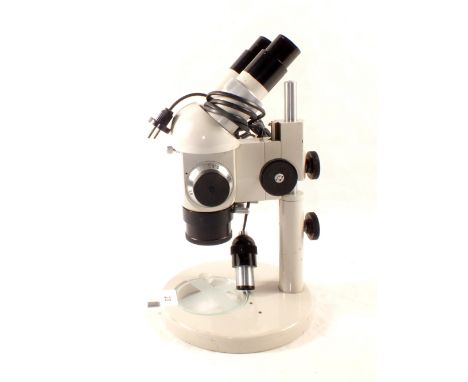 A 'Pzo' bifocal dissecting microscope with six variable magnifications on an adjustable stem (lacking the 6 volt power unit) 