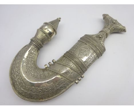 Yemeni (Meccan) Jambiya c1900 with 18cm curving ribbed steel blade and waisted hilt, in highly ornate Eastern silver scabbard