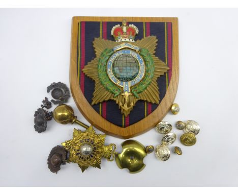 Royal Marines - helmet plate and finial, three officers two-piece bronze cap badges, buttons and shield mounted carved wooden