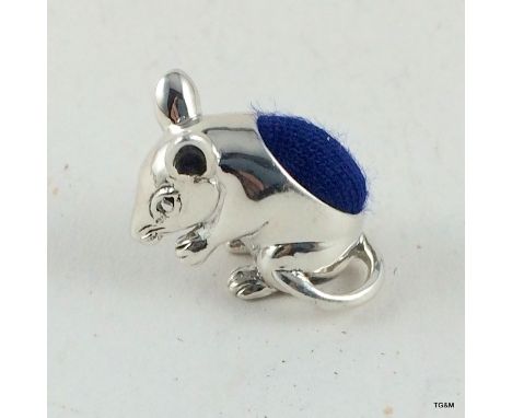 A silver mouse pincushion