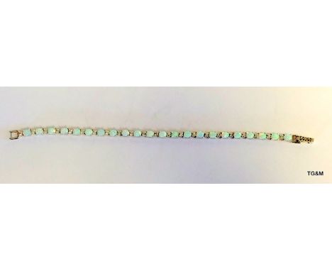 A silver Cz and opal line bracelet