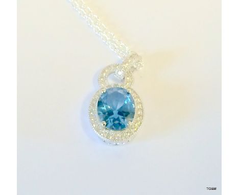 A silver Cz and blue topaz drop pendant necklace