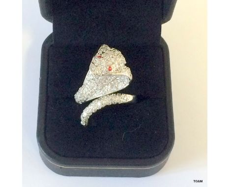 A silver and Cz snake ring with ruby eyes